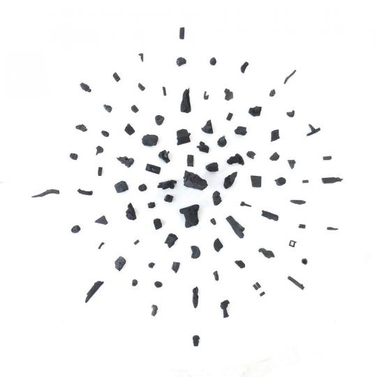affiche de petits morceaux de charbons dispersés en étoile sur fond blanc